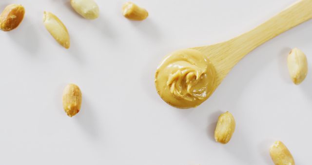 Creamy Peanut Butter on Wooden Spoon Surrounded by Peanuts - Download Free Stock Images Pikwizard.com