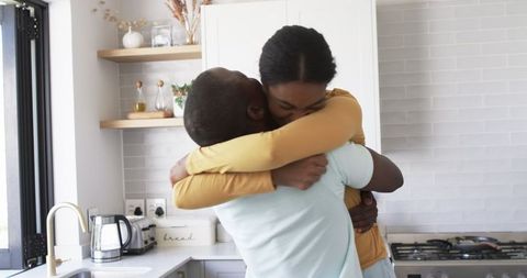 Affectionate African American Couple Embracing in Modern Kitchen
