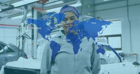Female mechanic in garage with world map overlay technology