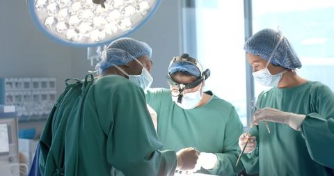 Surgeons Focusing During Operation in Modern Hospital