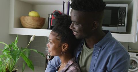 Content Couple Connecting Comfortably in Cozy Kitchen Setting