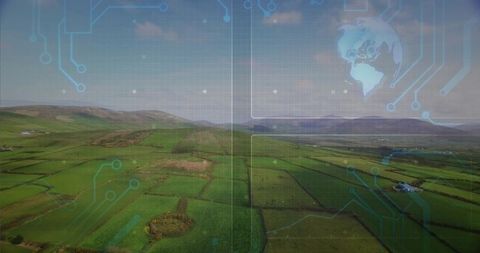 Aerial farmland stretching to coastline featuring blue circuit overlay for geospatial mapping