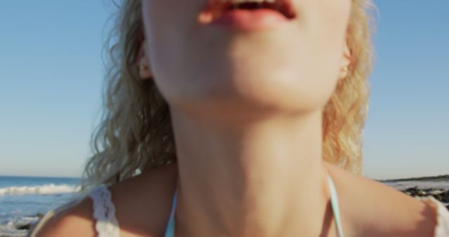 Close-up of woman enjoying sunny day at beach - Download Free Stock Images Pikwizard.com