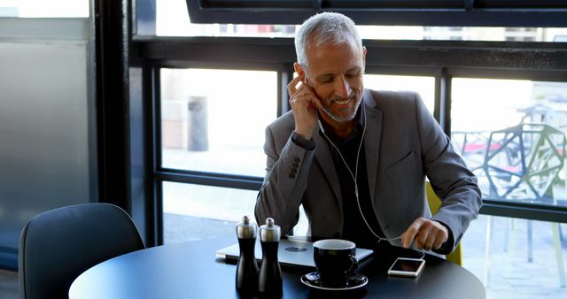 Smiling Businessman Making a Call in Modern Coffee Shop - Download Free Stock Images Pikwizard.com