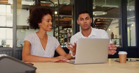 Colleagues Collaborating with Laptop in Modern Office Atmosphere - Download Free Stock Images Pikwizard.com