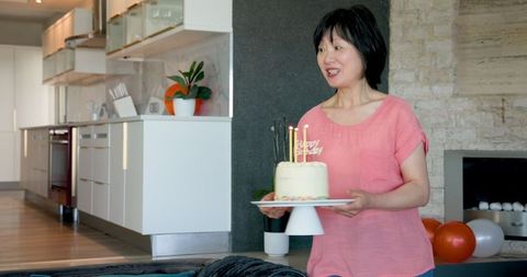 Senior Woman Celebrating Birthday Indoors with Friends