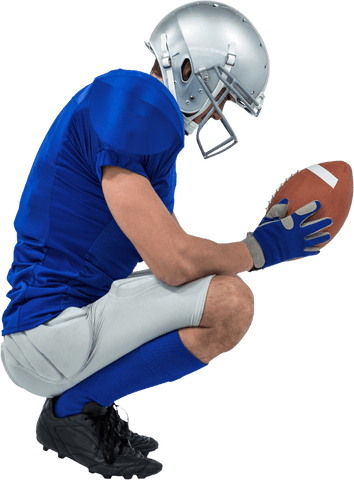American football player in crouch holding ball on transparent background
