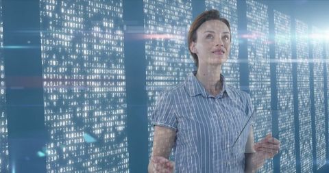 Woman interacting with futuristic virtual interface in tech environment