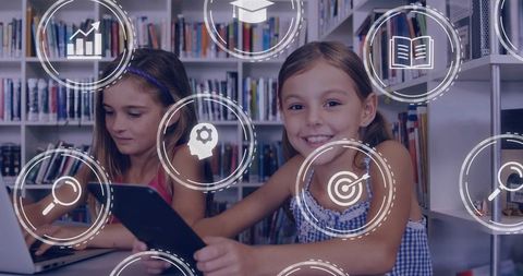 Smiling girl holding tablet in school library with digital learning icons, collaboration