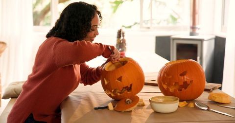 Woman Carving Pumpkins at Home for Halloween - Download Free Stock Images Pikwizard.com