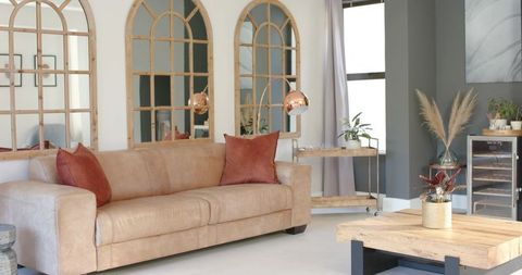 Cozy tan leather sofa inviting in modern farmhouse living room with copper accents