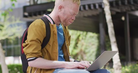 Young Digital Nomad Busy Working Outdoors on Laptop