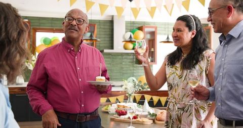 Senior Friends Celebrating Birthday with Smiles and Toasts