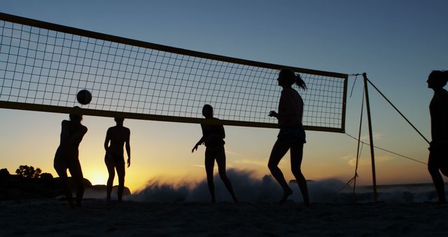 Group of Friends Playing Beach Volleyball at Sunset - Download Free Stock Images Pikwizard.com