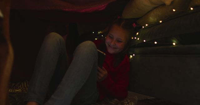 Smiling Girl Enjoying WiFi in Cozy Blanket Fort at Night - Download Free Stock Images Pikwizard.com