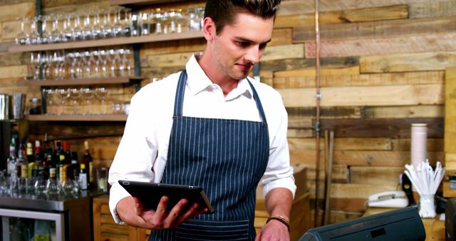 Barista using tablet and cash register in trendy cafe - Download Free Stock Images Pikwizard.com