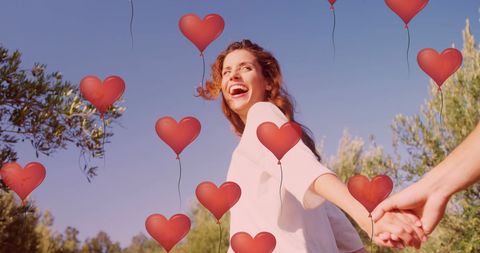 Romantic Couple Celebrating Love Amid Heart Balloons Outdoors