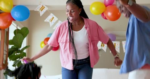 Excited Family Celebrating Birthday at Home with Party Streamers