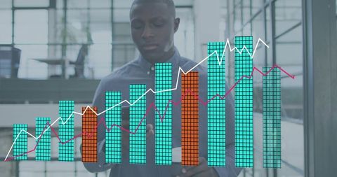 Businessman analyzing interactive bar chart on glass touchscreen in modern office atrium