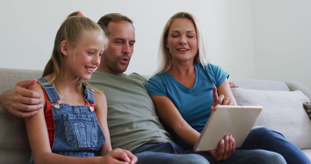 Happy Family Using Digital Tablet Together on Sofa - Download Free Stock Images Pikwizard.com