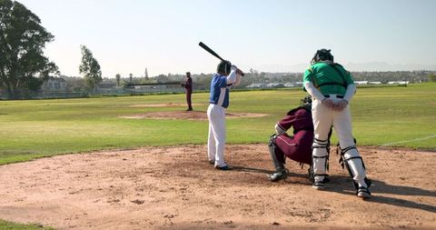 Baseball Players Ready for Pitch on Sunny Field