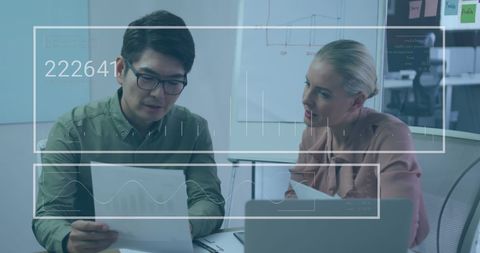 Business Professionals Analyzing Data in Modern Office Meeting