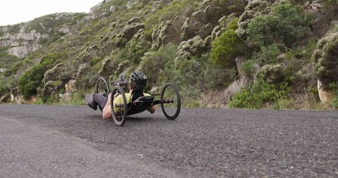 Man Enjoying Recumbent Bicycle Ride on Scenic Mountain Road