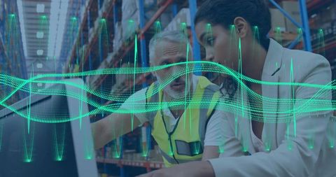 Warehouse team analyzing logistics data on laptop with neon data wave overlay