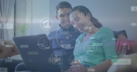 Couple Engaged with Futuristic Technology Interface on Laptop