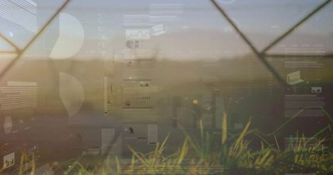 Diamond chain-link fence over meadow pastel sunrise blending with data overlay interface