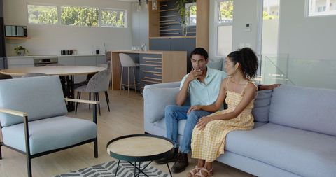 Young Couple Relaxing in Modern Minimalist Living Room Setting