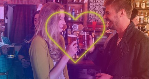 Neon heart connecting couple enjoying beers in vibrant bar atmosphere