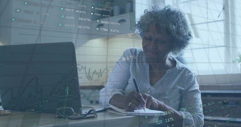 Senior African American Woman Analyzing Financial Data on Laptop