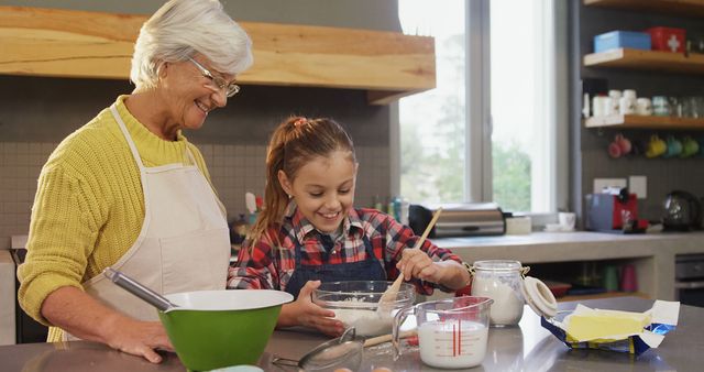 Grandmother and Granddaughter Smiling While Baking in Kitchen - Download Free Stock Images Pikwizard.com