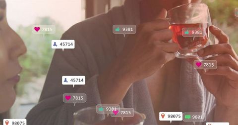 Couple sipping tea in bathrobes with social media engagement icons overlay, cozy morning