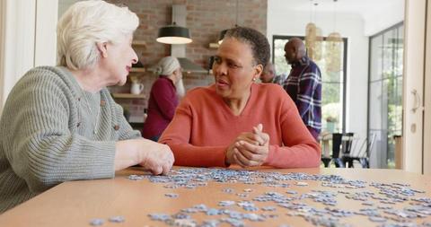 Senior Women Socializing and Doing Puzzle Together at Home - Download Free Stock Images Pikwizard.com