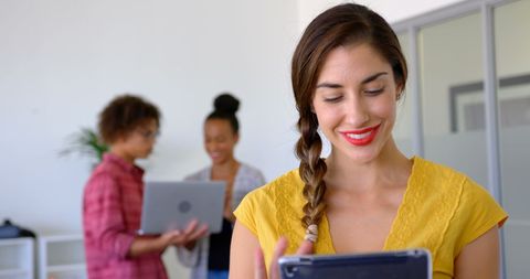 Diverse Team Collaborating with Digital Tablets in Bright Office