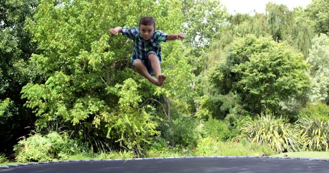 Child Jumping on Trampoline in Garden - Download Free Stock Images Pikwizard.com