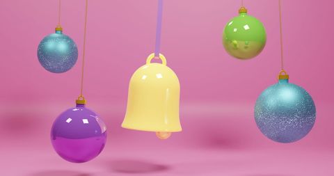 Colorful Christmas Baubles Hung Against Pink Background