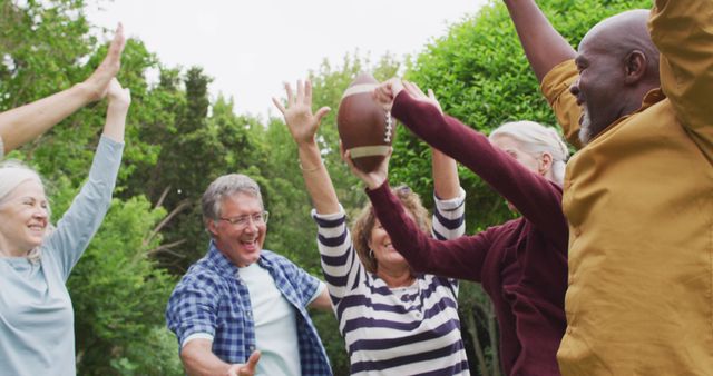 Image of happy diverse female and male senior friends playing american football in garden - Download Free Stock Photos Pikwizard.com