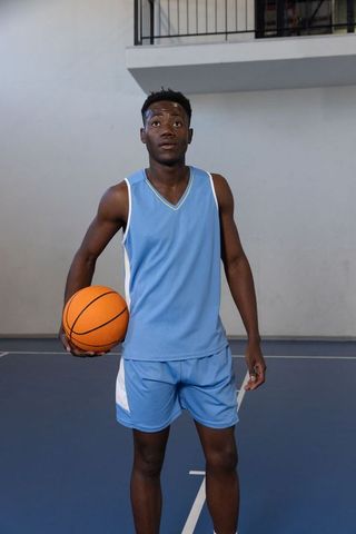 Confident African American Basketball Player in Action on Indoor Court