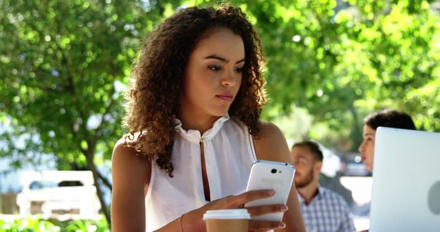 Young Woman Texting on Smartphone in Outdoor Cafe with Coffee - Download Free Stock Images Pikwizard.com