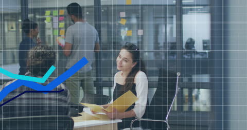 Diverse Team Analyzing Data Trends and Engaging in Discussion