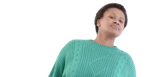 Thoughtful woman in green sweater on white background