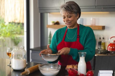 Senior woman baking in modern home kitchen
