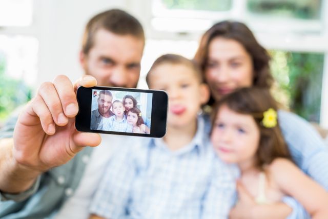 Happy family taking a selfie on mobile phone