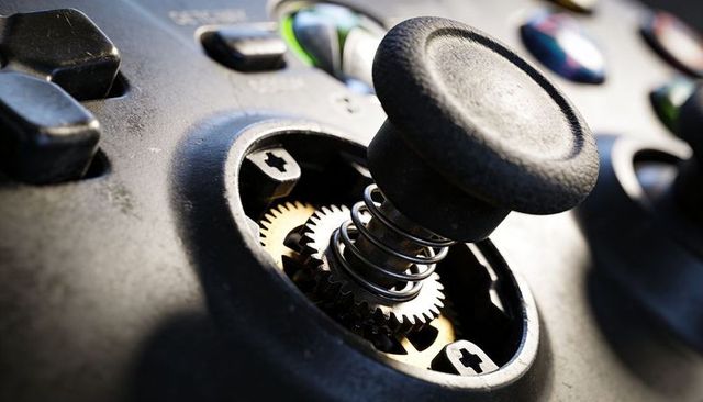 Macro joystick internals with rubber thumbstick, coil spring and brass gear mechanism