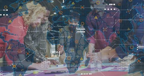 Multicultural team collaborating around table with global data overlays and creative swatches
