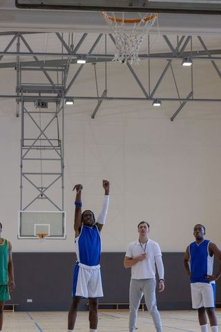 Diverse Male Basketball Team Practicing Free Throws in Gym