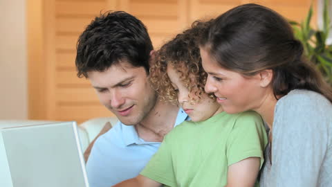 Happy Family Enjoying Digital Learning Together at Home